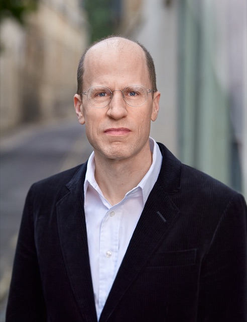 Portrait of Nick Bostrom in a dark jacket