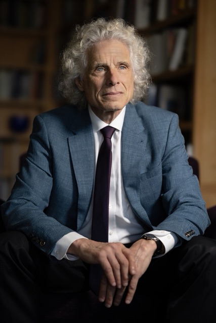 Steven Pinker, with long grey curly hair, in 2023